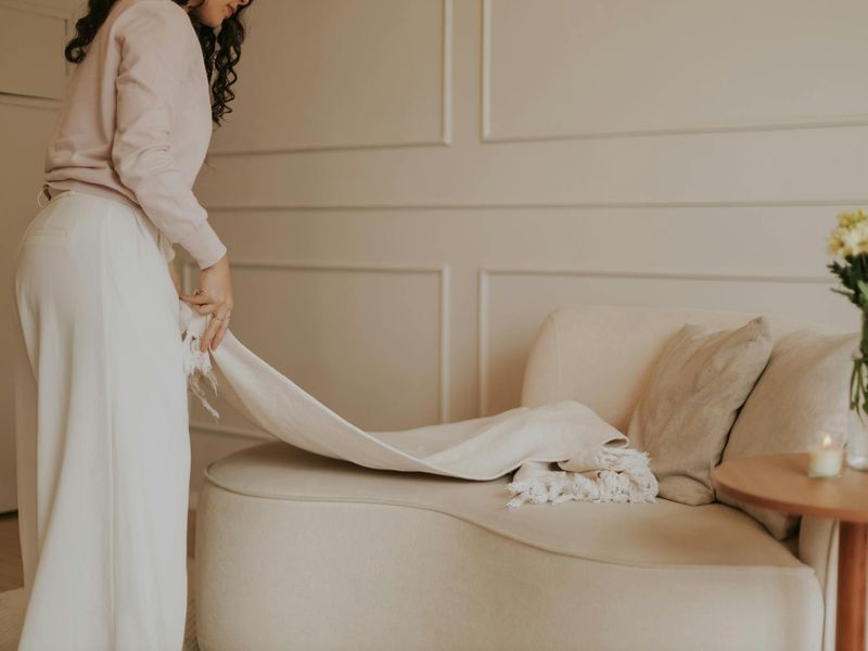 Person sitting calmly in a minimalist room with soft green light.